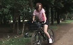 Japanese teen cutie rides bike with a dildo up in her cunt